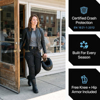 Woman rider walking out of a diner in the black RoadArmor Women's pants. Certified crash protection, built for every season, free knee and hip armor